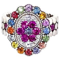 Super gorgeous and uniquely designed 2.41 Carat Multi Color Sapphire 14 Karat White Gold Cocktail Ring! This ring has a cluster of 31 Round Cut Natural Multi Color Sapphires that weigh 2.33 carats and 16 Round Cut Natural Diamonds that weigh 0.08 carats (Clarity: SI1, Color: F). The total carat weight of the ring is 2.41 carats. This ring is casted in 14K White Gold and weighs approximately 10.9 grams. This ring is a size 7 and can be re-sized at no additional charge. Multi Sapphire, Gold Cocktail Ring, Rainbow Brite, Gold Cocktail, Sapphire Diamond, Cocktail Ring, Cocktail Rings, Free Jewelry, Diamond White