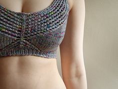 a close up of a woman's stomach wearing a knitted bra top and panties