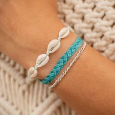 CORON BEACH BRACELET SET  Embrace the beauty of the ocean with our Coron Beach Bracelet Set. Crafted with ocean tones, this set will bring a touch of the sea to your everyday look. The perfect set of 3 bracelets for any beach lover! - Made with natural cowrie shells, a dainty silver chain, soft nylon cord and our durable wax polyester cord. - Bracelets measure approx. 17cm with a 7cm sliding knot extension on each side. - Handmade in Bali. - Biodegradable or recycled packaging. OTHER INFORMATION Beach Friendship Bracelets With Sliding Knot, Ocean-inspired Bracelets For Beach Season, Handmade Strand Braided Bracelets For Beach, Handmade Braided Strand Bracelets For The Beach, Vacation Strand Bracelets With Sliding Knot, Coastal Jewelry For Beach Party, Turquoise Strand Bracelets For Festival, Turquoise Bracelets For Beach Season Festivals, Handmade Braided Bracelets For Beach