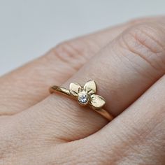 Diamond Snowdrop ring in 14k gold. Three handmade petals surround a sparkly white diamond. Comes on a 14k gold band with a hammered texture. Details : Diamond - 2.5mm Band - 1.6mm, hammered texture Finish - Choose between brushed satin and a shiny high polish at checkout. Pictured with the brushed satin finish. It's important to note that the photos are enlarged to show detail which can make the jewelry appear much larger than it is. Please look up the measurements I have noted on a ruler before Wedding Flower Ring With Single Diamond, Gold Flower Ring With Single Diamond For Wedding, Yellow Gold Flower Ring With Single Diamond For Wedding, Dainty Diamond Flower Ring For Anniversary, Gold Wedding Flower Ring With Single Diamond, Yellow Gold Flower Ring With Single Diamond For Promise, 14k Gold Wedding Flower Ring With Diamond Accents, Wedding Yellow Gold Flower Ring With Diamond, Diamond White Flower Ring With Single Cut Diamonds