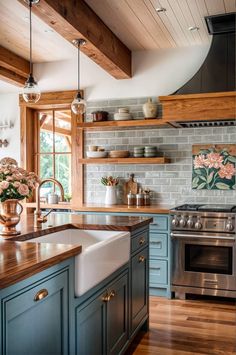 a kitchen with blue cabinets and wood floors