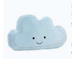 a blue cloud pillow with a smiley face on it's side, sitting in front of a white background