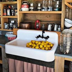 a kitchen sink with some lemons in it