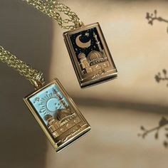 This is a gorgeous 18k, gold plated Sun (Shams) or Moon (Qamar) necklace. The Shams necklace features a beautiful pastel sky nestling a rising sun, surrounded by shimmery gold stars, while the Qamar necklace has a midnight starry sky, with a large gold moon. One of the stars on each necklace is inlaid with a dainty, sparkly gem. A golden masjid rises against the sky, three dimensional and intricately detailed. Below the scene, Shams / Qamar is written in Arabic, set between two tiny stars.  The Sun And Moon Necklaces, Moon Necklaces, Sun And Moon Necklace, Islamic Jewelry, Pastel Sky, Tiny Star, Friendship Necklaces, Gold Moon, In Arabic