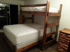 there is a bunk bed with two sets of mattresses on it