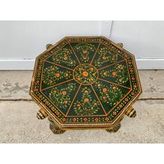 an ornately decorated table on the ground