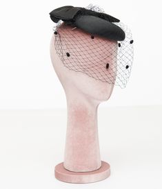 Step back in time with an enchanting accessory that adds a touch of classic elegance to any outfit! This charming 1950s pillbox hat from Unique Vintage, features a delightful oversized black bow perched atop, perfectly complemented by its delicate mesh veil. Whether you're attending a garden party or simply want to elevate your everyday style, this fascinator is sure to turn heads and spark conversations..Available while supplies last. | Unique Vintage 1950S Black Bow Pillbox Fascinator Hat Pillbox Fascinator, Elegant Hats, Fascinator Hat, Pillbox Hat, Fascinator Hats, Pill Boxes, Step Back, Black Bow, Back In Time