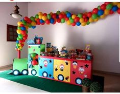 a birthday party with balloons and decorations on the wall, including an ice cream truck