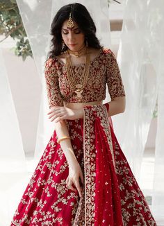 Red Floor-length Choli For Transitional Season, Red Traditional Wear With Cutdana For Reception, Red Cutdana Gown For Eid, Red Cutdana Traditional Wear For Reception, Red Cutdana Choli For Eid, Red Kundan Sets For Transitional Season, Festive Red Gown With Cutdana, Red Raw Silk Gown For Navratri, Red Lehenga With Dori Work For Traditional Ceremonies