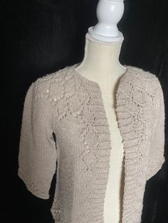 "Handmade vintage cardigan in a light brown color. Has stretch to it and half sleeves. No label and I'm not positive on era... could be as old as 1940's or as new as 1970's since it's very stretchy Women's small medium 40\" max bust 23\" shoulder to hem" Fitted Beige Open Knit Outerwear, Fitted Vintage Knitted Cardigan, Vintage Knitted Spring Cardigan, Fitted Cream Knit Cardigan, Cozy Fitted Hand-knitted Cardigan, Cozy Fitted Hand Knitted Cardigan, Vintage Open Knit Cardigan For Fall, Fitted Vintage Knit Outerwear, Vintage Beige Knit Outerwear