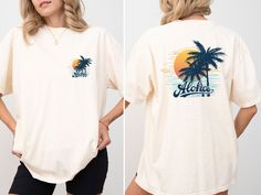 This stylish beach shirt is perfect for celebrating your holiday dreams and summer vacations. It's a comfortable and stylish option to wear at the beach during your summer vacation, on nature hikes, or any outdoor activity. M A T E R I A L S → All our simple color ones like White and Black are 100% Cotton. → All our Heathered Colors are cotton/polyester blend and they are super comfy soft! → Short Sleeve Crew-Neck Unisex T-Shirt → Soft and High-Quality Fabric → Sueded Jersey → Pre-shrunk → Taped shoulder-to-shoulder → Tear away label → Side Seamed → Retail fit S I Z E → We have size chart on our listing photos. S H I P P I N G & P R O D U C T I O N T I M E → Production time is 1-3 business days (depending on proof approval). → Shipping Time is 1-5 Business Days. → If you are in a RUSH, Ple White Relaxed Fit Camp Shirt For Beach, White Relaxed Fit Camp Shirt For The Beach, Summer Hawaiian Shirt With Letter Print, White Hawaiian Shirt With Palm Tree Print For Vacation, Tropical Tops For Summer Adventures And Vacation, Relaxed Fit Graphic Print Camp Shirt For Beach, Casual Pre-shrunk Shirt For Beach, Summer Beach Shirt With Palm Tree Print, Summer Shirt With Palm Tree Print For Beach