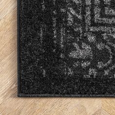 an area rug with black and white designs on it