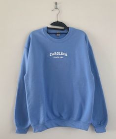 If you want a custom order or have any questions, please message me! -North Carolina Chapel Hill embroidered crewneck -50/50 cotton/polyester -Unisex sizing: fits true to size. Order one size up for a looser fit. -All gift messages are handwritten Blue Crew Neck Top With Custom Embroidery, Custom Embroidered Cotton Crew Neck Sweatshirt, Cotton Crew Neck Sweatshirt With Letter Embroidery, Blue Cotton Sweatshirt With Custom Embroidery, North Carolina Chapel Hill, Unc Chapel Hill, Summer Outfits For Teens, Embroidered Crewneck, Chapel Hill