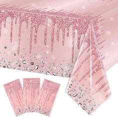 pink table cloths and napkins with water droplets on them, set against a white background