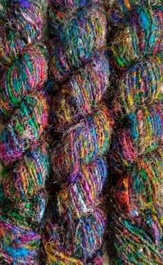 several skeins of multicolored yarn sitting on top of each other