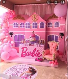 a pink barbie doll house with balloons and furniture in the room, including a cake table