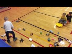 two boys are playing with toys on the floor