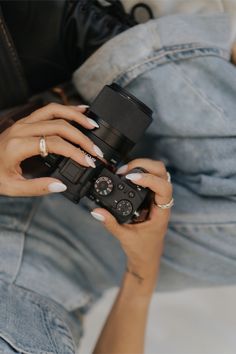 a woman holding a camera in her hands