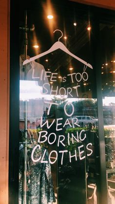 there is a sign in the window that says, we're too short to wear boring clothes