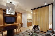 a living room filled with furniture and a flat screen tv sitting on top of a wooden table