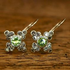 This Georgian era design is memorable for both its elegance and piety. The central peridot is circled by diamonds to form a cross of 14k gold.1" tall by 5/8th" wide with french-backs for pierced ears. Green Multi-stone Diamond Earrings, Green Diamond Multi-stone Earrings, Elegant Lime Green Diamond Jewelry, Madame Bovary, Georgian Era, Lapis Earrings, Historical Jewellery, Spring Jewelry, Zirconia Earrings