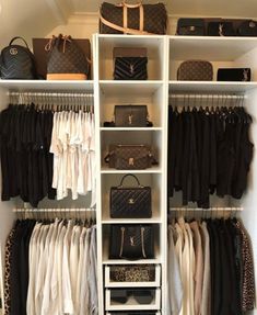 an organized closet with white shelving and black handbags on the shelves, including purses