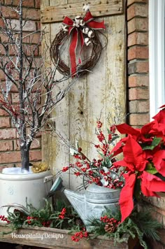 christmas decorations on the front porch with red poinsettis and greenery in buckets