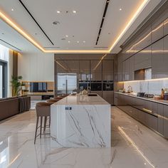 a large kitchen with marble counter tops next to a living room and dining room area