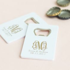 two bottle openers with initials on them