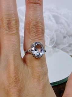 Natural White Topaz Ring, 5 carat oval faceted gemstone,  Sterling Silver Floral Filigree, Edward design #D70z, offset front side view Edwardian Jewelry, Silver Filigree, Topaz Gemstone, Topaz Ring, White Topaz, Leaf Design, Sapphire Ring, Topaz, Sapphire