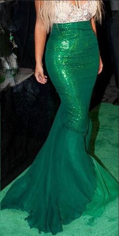 a woman in a green mermaid style dress