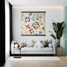 a living room with a white couch and large painting on the wall