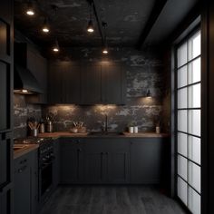 an empty kitchen with black cabinets and wood flooring is lit by recessed lights