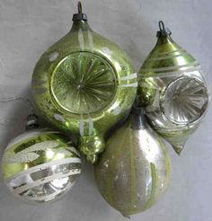 green glass ornaments hanging on a wall