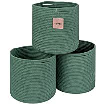 three green round baskets sitting next to each other on top of a white surface with a tag