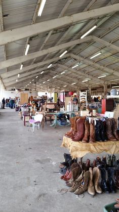 there are many pairs of boots on display in the store's open air area