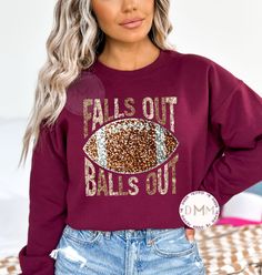 Falls Out Balls Out Football Sweatshirt.  Faux Glitter Sequins design. *Maroon sweatshirt displayed on main photo. Sweatshirt is unisex. For an oversized look, size up at least 2 sizes. *If you like this design, but want it on a different style shirt, send a message before purchase. --------------------------------------------- PROCESSING TIME: 3-7 business days (M-F) before an item ships. If you need something sooner, please send a message before purchase. SIZING: A size chart is available in t Fall Fan Gear Long Sleeve Sweatshirt, Fall Fan Gear Sweatshirt With Graphic Print, Fall Fan Gear Graphic Sweatshirt, Fan Gear Graphic Print Sweatshirt For Fall, Fan Apparel Sweatshirt With Ribbed Cuffs For Fall, Fall Fan Gear Sweatshirt With Crew Neck, Glitter Print Crew Neck Tops For Fall, Crew Neck Top With Glitter Print For Fall, Fan Apparel Graphic Print Sweater For Fall