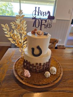 a three tiered cake on a wooden table