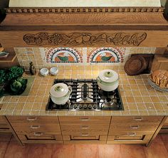 a stove top oven sitting inside of a kitchen next to a wooden cabinet and counter