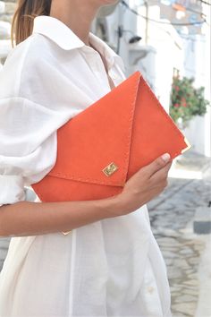 "Soft Symmetria Clutch in coral. The perfect bag for all occasions! Ideal for cocktail and parties or for business meetings depending the size you choose. It comes in two sizes, small and large. You can use it as a chic briefcase for your work or as a modern large clutch for a night out. This adorable large clutch is handmade out of a genuine, lux Italian coral suede leather. -Small size fits all your essentials, wallet, keys, mobile, cosmetics etc. -Large size fits a 15\" laptop, ipad, portofol Chic Everyday Envelope Clutch, Chic Orange Clutch For Everyday Use, Elegant Orange Clutch As A Gift, Chic Envelope Clutch For Daily Use, Everyday Envelope Clutch, Chic Orange Clutch, Elegant Orange Rectangular Clutch, Chic Clutch With Magnetic Closure As Gift, Envelope Clutch With Removable Pouch