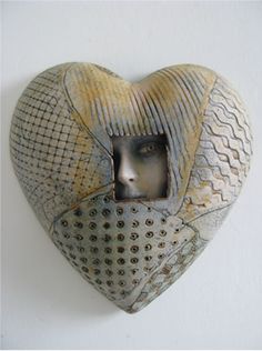 a heart shaped sculpture with a woman's face in the center