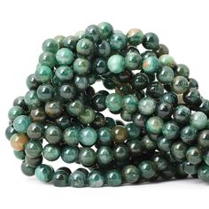 green marble beads are stacked on top of each other