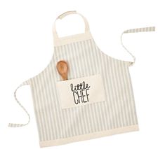 a little chef apron with a wooden spoon in it and a name tag on the front