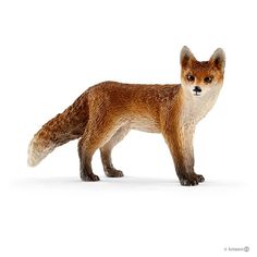 a toy fox is standing on a white surface