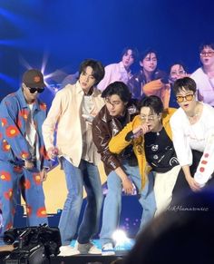 a group of young men standing on top of a stage