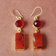 Feel the vibrant energy of this earring inspired by “Agni” or fire we have handmade this dangle earring. Natural high quality carnelian stone is moulded in gold plated brass work to give lustre and shine to the design. The gold detailing and the delicate hook enhance and allow flexibility to the design. Comfortable to wear throughout the day this earring will be transition seamlessly for any occasion; and a pretty little gift for Christmas.One-of-a-Kind Earrings - Natural Stone Earrings - Carnel Carnelian Amber Earrings For Gift, Amber Carnelian Earrings Gift, Carnelian Drop Earrings As Gift, Carnelian Drop Earrings For Gift, Rectangular Natural Stone Earrings For Gifts, Orange Carnelian Earrings For Gift, Pierced Carnelian Drop Earrings, Red Carnelian Earrings Perfect As A Gift, Red Carnelian Pierced Earrings