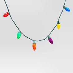 multi - colored christmas lights are hanging on a string