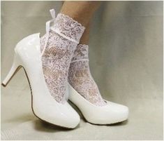 COSMOPOLITAN lace socks for heels - white Elevate your look with our stretch lace socks with satin bows. Perfect for heels and Mary Jane shoes. Great sock style for a modern wedding, special occasion. Step into elegance with our COSMOPOLITAN lace socks for heels in white. These socks feature a delicate and stretchy lace design adorned with satin bows, perfect for stepping into your favorite heels or Mary Jane shoes. Add a touch of luxurious sophistication to any outfit with these lace socks, perfect for a modern wedding or special occasion. delicate nylon lace sock no heel, fits average feet 6-9 exclusive design * Signature socks by Catherine Cole Quality lace socks for women  Women have been calling our socks their signature look for many years Sheer Socks Wedding, Oxfords Sheer Socks, Elegant Luxury Wedding Lace-up Shoes, Elegant Luxury White Lace-up Shoes, Elegant Luxury Lace-up Shoes For Wedding, Luxury White Mary Janes For Women, Luxury Fitted Lace Wedding Shoes, Wide Foot Sock Heels, Elegant Luxury Lace-up Wedding Shoes