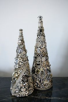 two decorative christmas trees sitting on top of a table