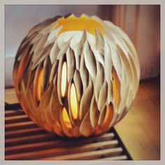 a carved pumpkin sitting on top of a wooden floor next to a window sill